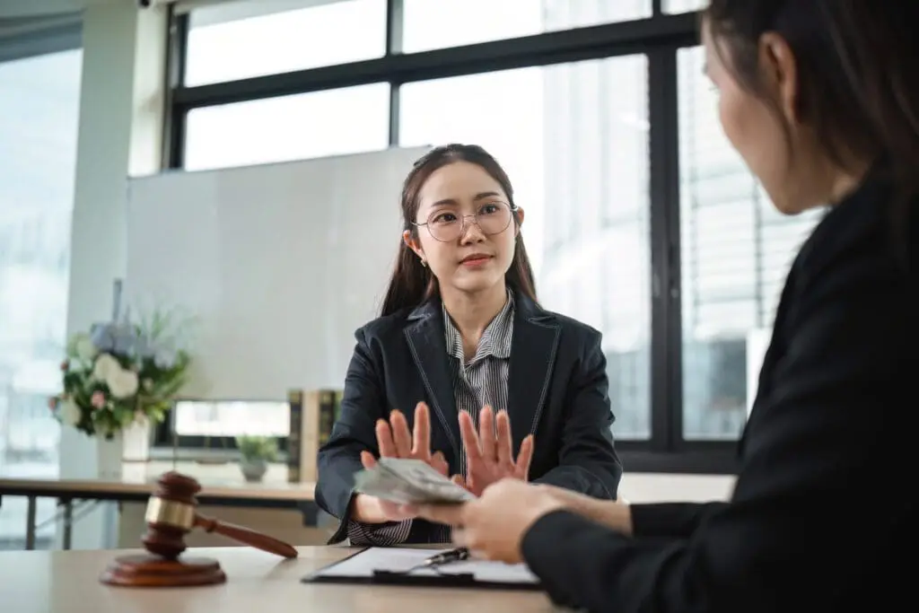 Two women discussing debt negotiation